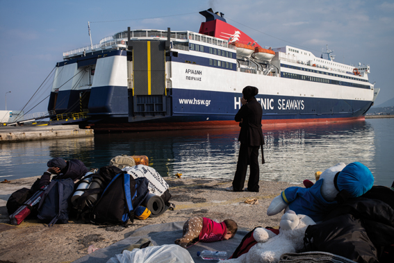 A Syrian family waiting to be embarked on a ferry - which will bring them to the peninsula- at Mytilene's port on March 20, 2016.